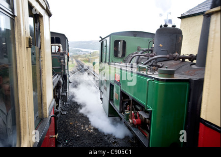 Two engines on the Rack and Pinion Snowdon Mountain Railway pass on the mountain track. Stock Photo