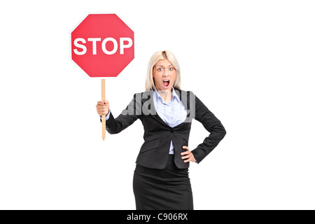 Young businesswoman holding a traffic sign stop Stock Photo