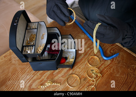 Burglar in a private house. Daylight burglary. Breaking into a house, an apartment to steel valuables. Stock Photo