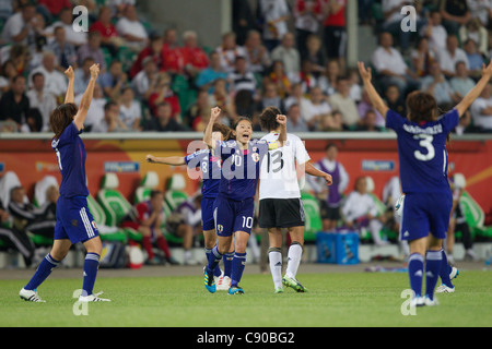 Japan captain Homare Sawa (10) and teammates celebrate at the final whistle after defeating Germany in a World Cup quarterfinal. Stock Photo