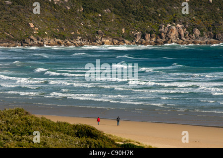 Two hikers walking along Norman Beach, Wilsons Promontory National Park, Victoria, Australia Stock Photo