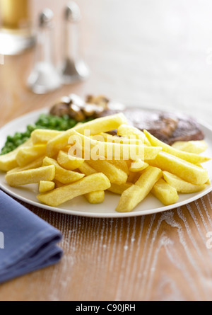 chips with steak and peas Stock Photo