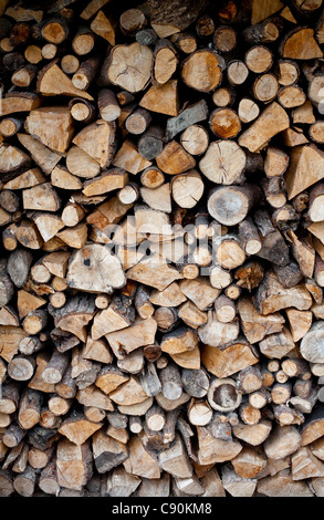 A pile of logs stored ready for use as domestic fuel in a wood burning stove at a home in Shropshire, UK Stock Photo