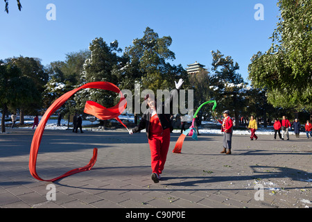 Morning sport in Jingshan Park female dancer performing a rhythmic dancing ribbon dance exercise early in the morning Beijing Pe Stock Photo