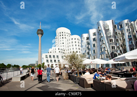 People and modern buildings under clouded sky Neuer Zollhof Frank O. Gehry Media Harbour Duesseldorf Duesseldorf North Rhine-Wes Stock Photo