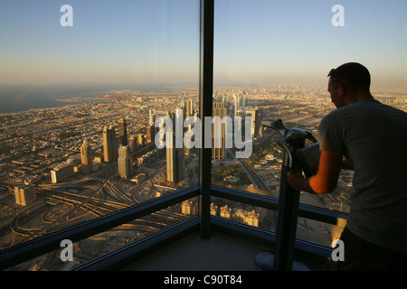 Man enjoying the view from the Observation Deck At The Top Burj Khalifa Burj Chalifa Sheikh Zayed Road Dubai United Arab Emirate Stock Photo