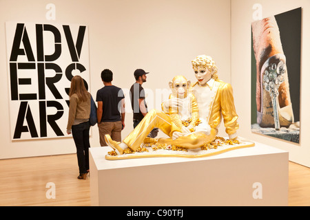 Sculpture Michael Jackson with his monkey gold figure modern art visitors avantgarde contemporary art San Francisco Museum of Mo Stock Photo