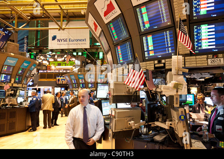 Broker near screens New York Stock Exchange center of the financial world Manhattan New York City United States of America USA Stock Photo