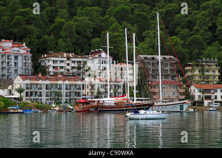 Fethiye, Turkey, from the harbour. Tall ships, gulets, and smaller sailing yachts moored in the sheltered harbour. Stock Photo