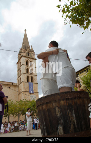 Men pressing grapes at grape harvest festival in Binissalem Mallorca, Majorca Balearic Spain Stock Photo