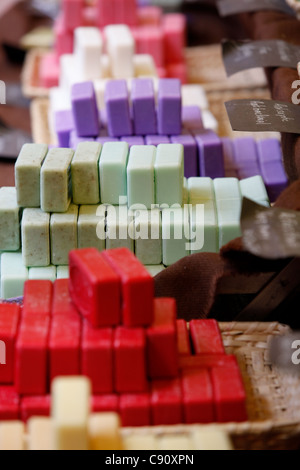 Colourful handmade soaps displayed on a market stall Stock Photo