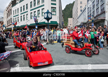 People driving toy cars. 4th July parade. Juneau. Alaska. USA Stock Photo