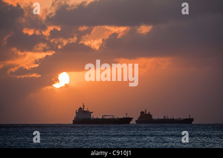 The Netherlands, Oranjestad, Sint Eustatius Island, Dutch Caribbean. Oil tankers. Sunset. Stock Photo