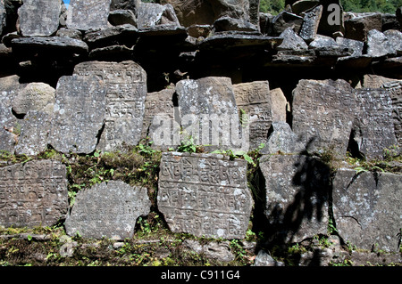 Mani stones are found along the mountain paths and trekking and climbing routes in the Himalayan foothills and regionof Stock Photo