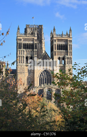West face of Durham cathedral towers through trees in Autumn, Durham city, north east England, UK Stock Photo