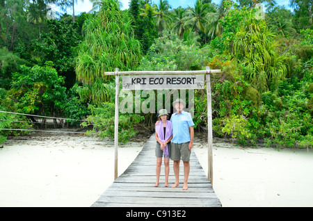 Couple posing at entrance to Kri Eco Resort, Raja Ampat islands near West Papua, Indonesia in the coral triangle, Pacific Ocean. Stock Photo
