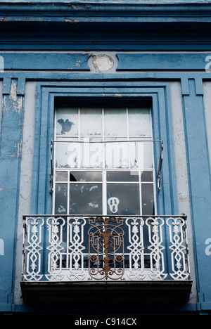 Mask in window of blue house with balcony in Puebla, Mexico. Stock Photo