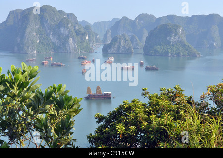 Traditional two masted Vietnamese junks are a popular way for visitors to see Ha Long Bay and the landscape of limestone rock Stock Photo