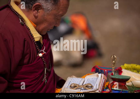 Buddhist priest reading from scrolls in traditional ceremony, Sagarmatha National Park, Nepal Stock Photo