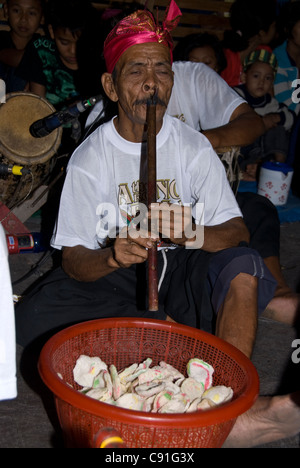 Gamelan musician playing flute-like instrument in circumcision ceremony, Randublatung village, near Cepu Stock Photo