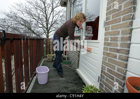 A woman is cleaning her windows Stock Photo