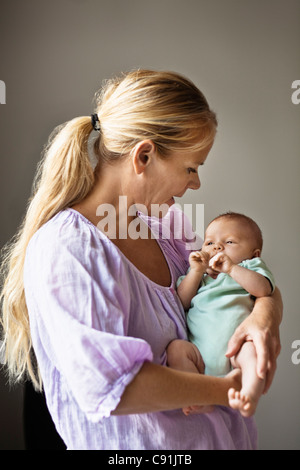 Mother cradling infant Stock Photo