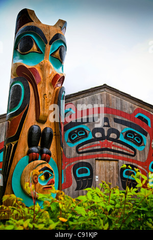 Close up of Raven totem pole and Beaver House at Saxman Totem Park, Ketchikan, Southeast Alaska, Summer Stock Photo