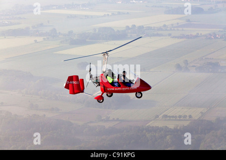 Aerial view of a two-seater autogyro, gyrocopter above a winter ...