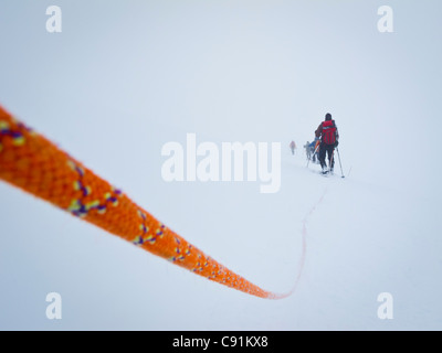 Rope team mountaineering in a whiteout on the Kahiltna Glacier, Mt. McKinley, Denali National Park & Preserve, Interior Alaska Stock Photo