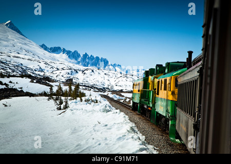 White Pass & Yukon Railroad on an early Summer excursion with snow still on the ground, Skagway, Southeast Alaska Stock Photo