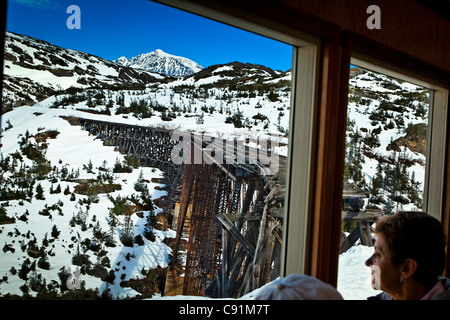 The window view from White Pass & Yukon Route Railway of the oldest trestle on the line, Skagway, Southeast Alaska, early Summer Stock Photo