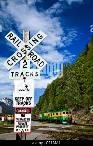 White Pass & Yukon Route Railway Train at a railroad crossing, Skagway, Southeast Alaska, Summer Stock Photo