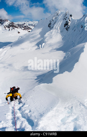 Mountaineer on a rope belay climbing down The Great Wall, from a 8700-foot pass in the Tordrillo Mountains in Alaska Stock Photo