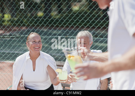 Older people having lemonade outdoors Stock Photo