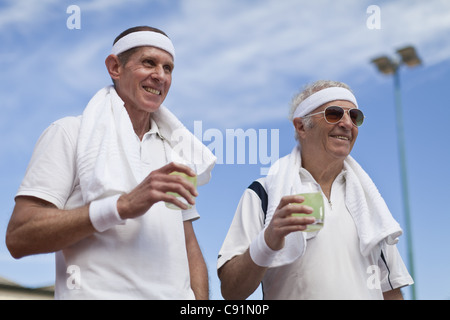 Older men drinking lemonade outdoors Stock Photo