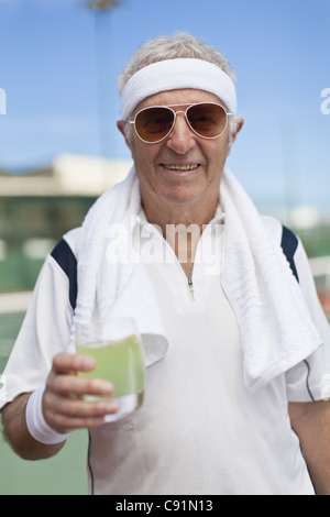 Older man drinking lemonade outdoors Stock Photo