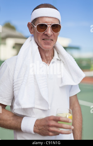 Older man drinking lemonade outdoors Stock Photo