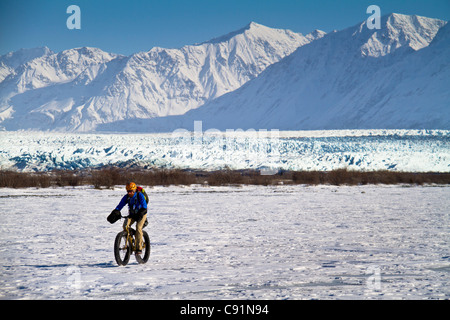 Man Fat Tire mountain biking on the Knik Glacier, Chugach Mountains, Southcentral Alaska, Winter Stock Photo