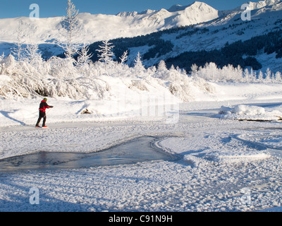 Man Nordic ice skating on the frozen Placer River, Kenai Mountains, Southcentral Alaska, Winter Stock Photo