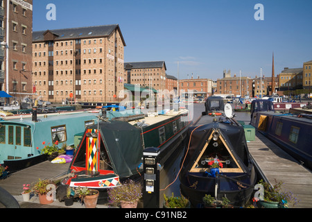 Gloucester England View across narrow boats moored in Victoria dock to The Candle sculpture Soldiers of Gloucestershire Museum Stock Photo
