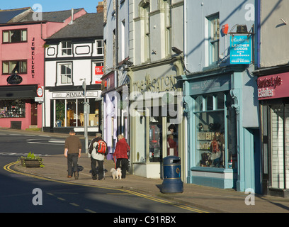 Three people walking along King Street, Ulverston, Cumbria, England UK Stock Photo