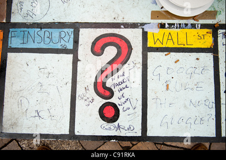 Anti capitalist comments are seen on a large spoof Monopoly Game board at 'Tent City' St Pauls Cathedral, London, UK. Photo: Graham M. Lawrence. Stock Photo