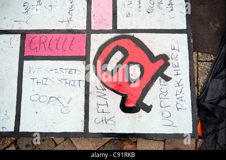 Anti capitalist comments are seen on a large spoof Monopoly Game board at 'Tent City' St Pauls Cathedral, London, UK. Photo: Graham M. Lawrence. Stock Photo