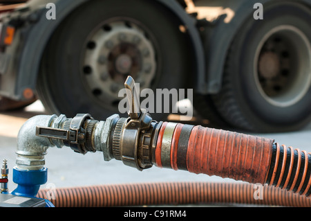Big Truck Hoses for fuel station, pumps and oil barrels Stock Photo