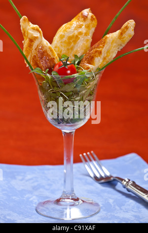 Puff pastry filled with cream cheese on croissants and Swiss mountain cheese cress bed  Stock Photo