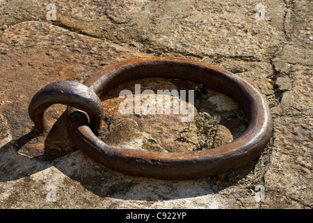 Iron mooring ring set in a paving slab on the bank of the river Douro which is used for mooring boats. Stock Photo