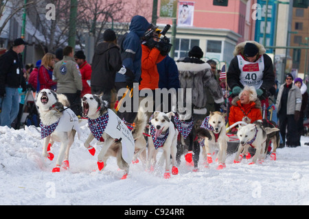 GB Jones mushes down 4th Ave. during the ceremonial start of the 2011 Iditarod, Anchorage, Southcentral Alaska, Winter Stock Photo