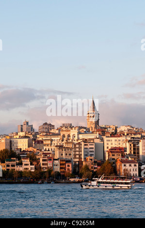 Late afternoon sun shining on the Galata skyline, viewed from Eminonu, Istanbul, Turkey Stock Photo