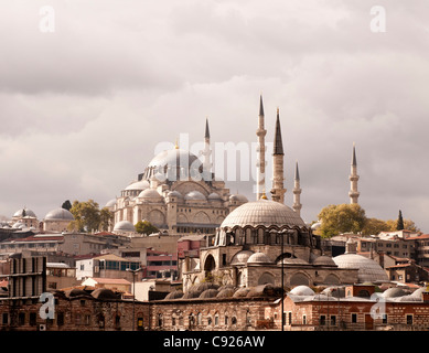 Late afternoon sun shining on Suleymaniye Mosque and Rustem Pasa Mosque, viewed from Eminonu, Istanbul, Turkey Stock Photo