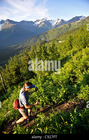 Woman hikes the steep North Face Trail at Alyeska Resort in Girdwood, Southcentral Alaska, Summer Stock Photo